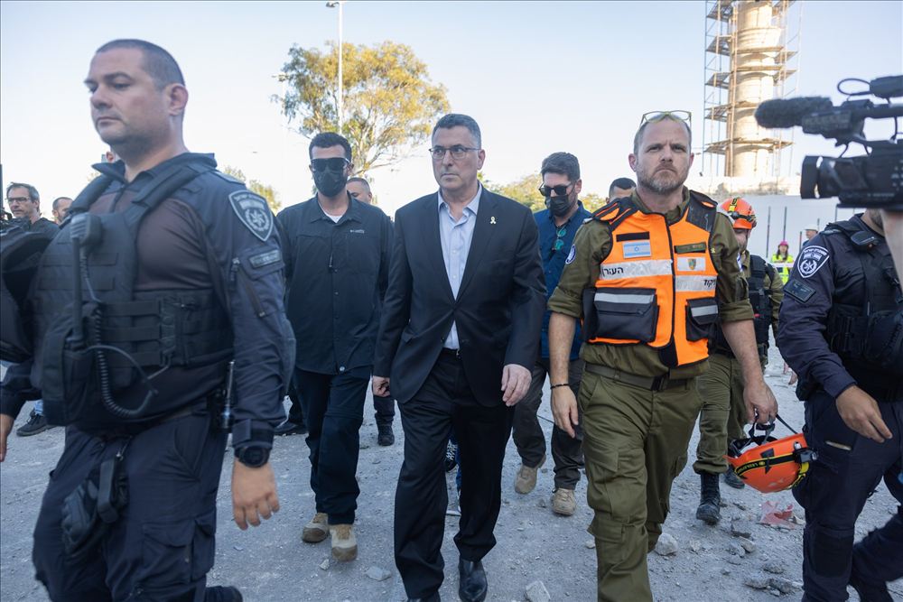 אנשי ציבור בליווי כוחות ביטחון צועדים בזירת אירוע
